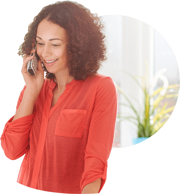 A woman talking on a phone and using fiber Internet home phone service